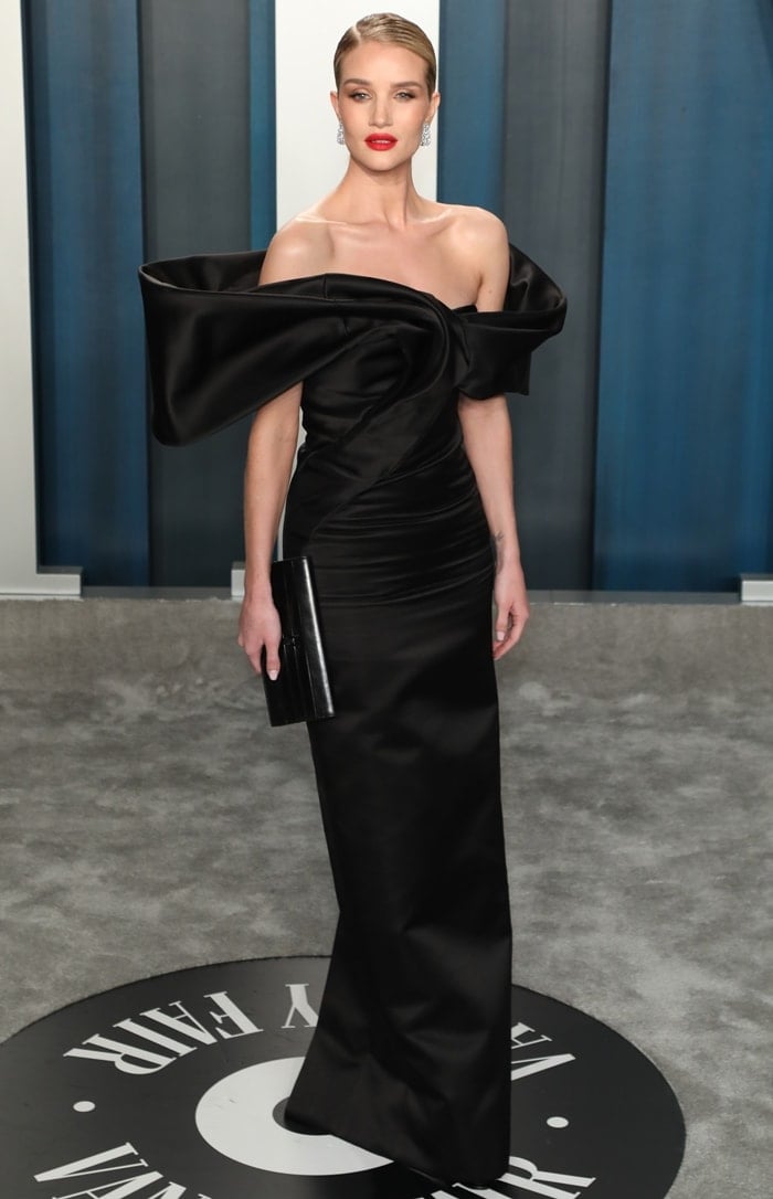 Rosie Huntington-Whiteley styled her off-the-shoulder satin Saint Laurent gown with a slick side-parted bun and Lorraine Schwartz diamond earrings