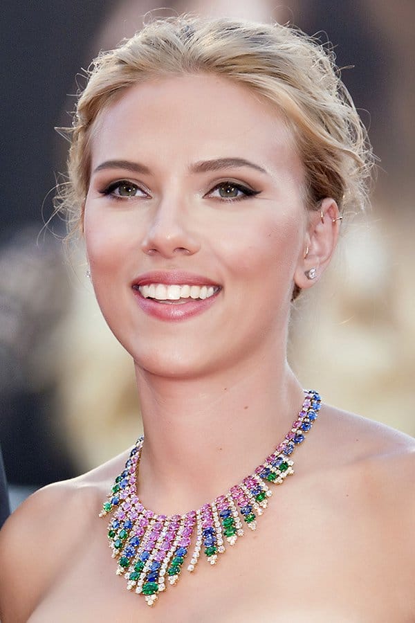 Scarlett Johansson's necklace features yellow gold with pink and blue sapphires, emeralds, and round brilliant cut diamonds