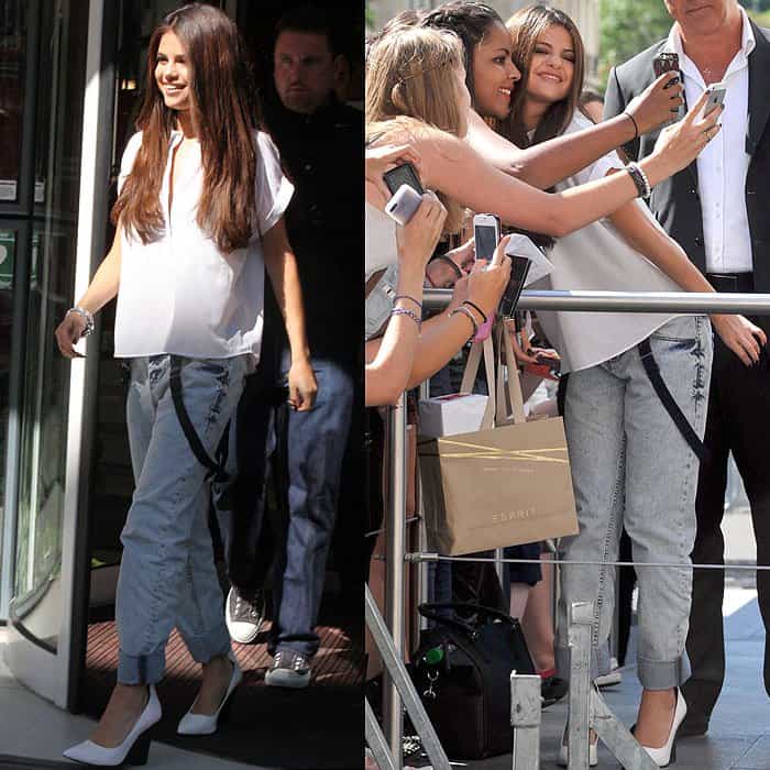 Selena Gomez greeting and posing with fans outside the NRJ studios in Paris, France, on September 5, 2013