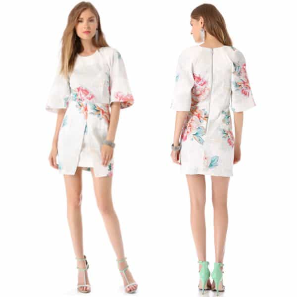 A fitted, floral twill dress is styled with a split panel over the skirt and wide, elbow-length sleeves