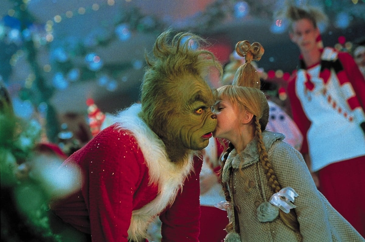 Cindy Lou Who, played by Taylor Momsen, shares a heartwarming moment with Jim Carrey's Grinch in How the Grinch Stole Christmas (2000)