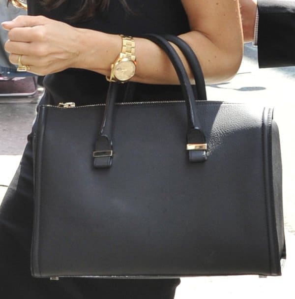 Victoria Beckham carrying a black 'The Victoria' mini matte-leather tote in black