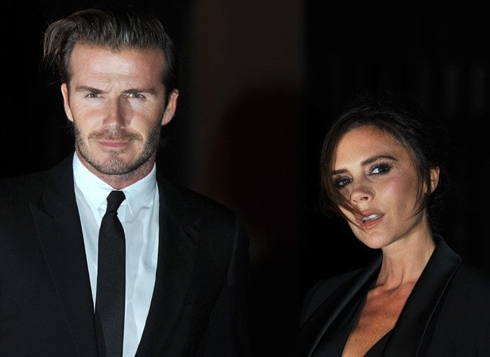 David and Victoria Beckham attend a formal event, both dressed in sleek black attire