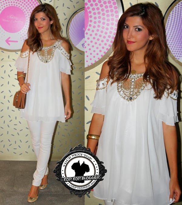 Zumra in a white dress top with matching pants