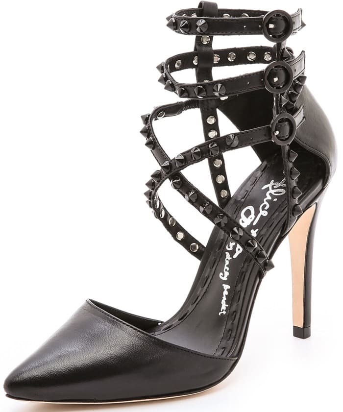 Tonal spikes accent slender straps on these smooth leather alice + olivia pointed-toe pumps