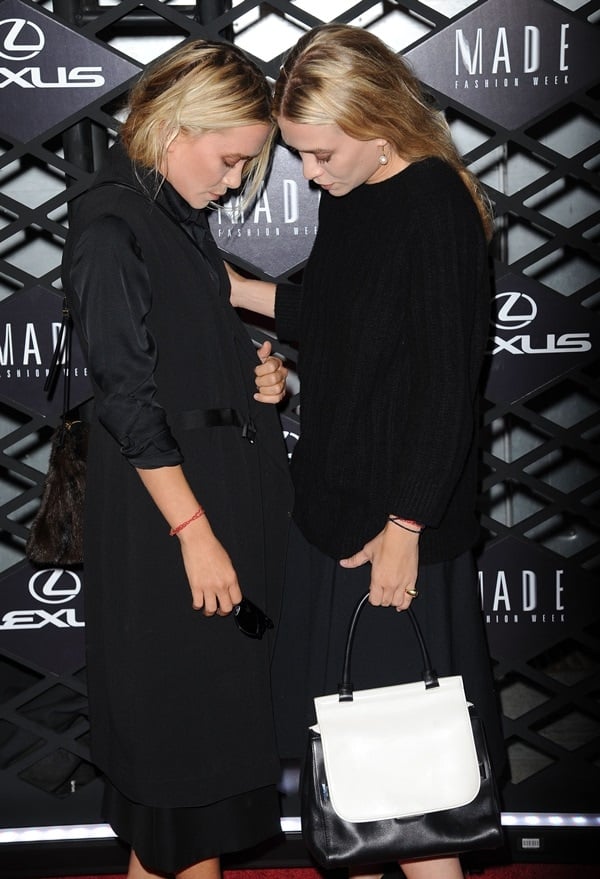 Mary Kate and Ashley Olsen at the Lexus Design Disrupted Fashion Experience during Spring 2014 Mercedes-Benz Fashion Week in New York, showcasing their distinct oversized fashion