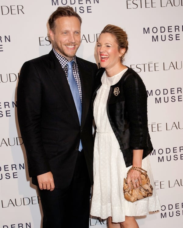 Drew Barrymore happily posing for photographs on the red carpet with friend and InStyle editor Ariel Foxman