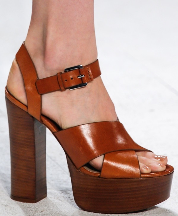 Tan leather platform sandal with crisscross straps and a chunky wooden heel