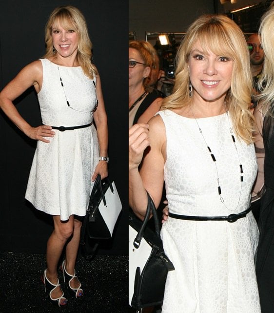 Ramona Singer looks chic in a classic white dress with a black belt, accessorized with a coordinating handbag and stylish open-toe heels during 2014 Mercedes-Benz Fashion Week