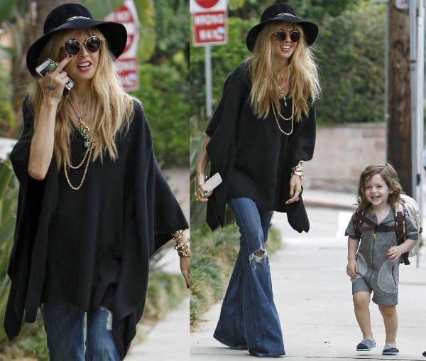 Showing already? Pregnant Rachel Zoe puts on a large poncho for her walk around town
