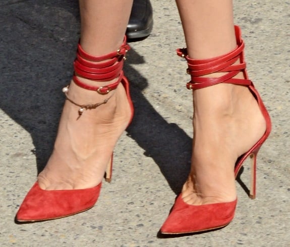 Uma Thurman channeling nautical with stripes and finishing her look with sexy wrap-around ankle-strap pumps during 2014 Mercedes-Benz Fashion Week in New York City on September 9, 2013