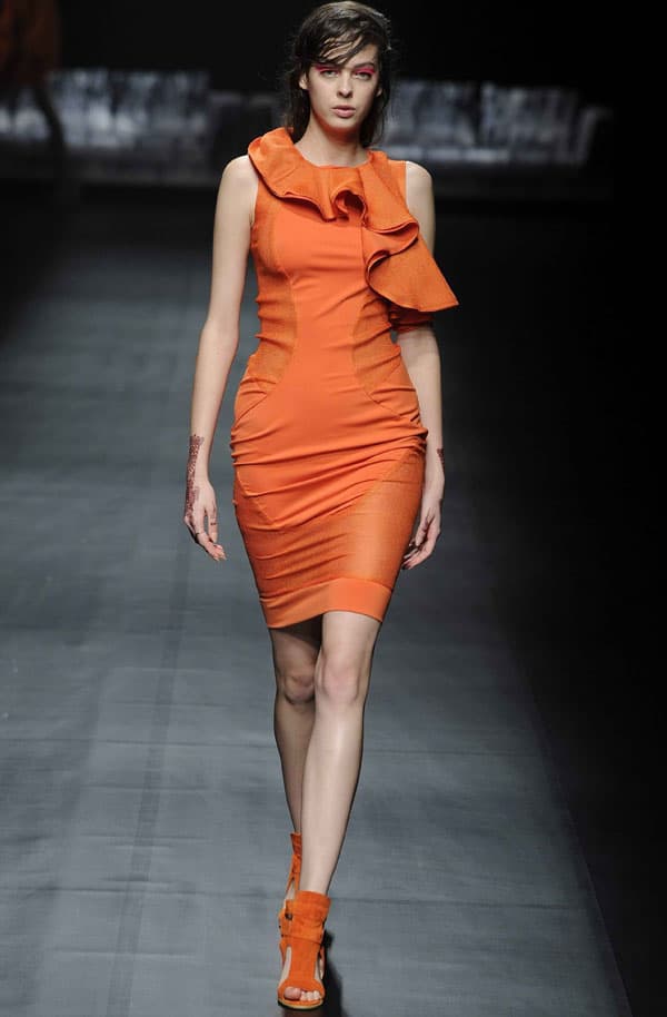 Model wearing an orange dress with intricate panel work by A Degree Fahrenheit at Tokyo Fashion Week