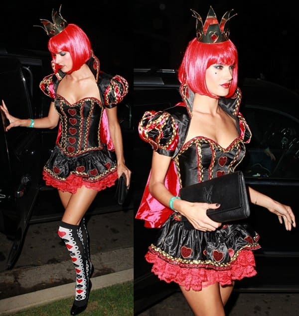 Alessandra Ambrosio stuns as the Queen of Hearts from 'Alice in Wonderland' in a bold, sexy costume complete with a red bob wig, crown, and lace-up boots