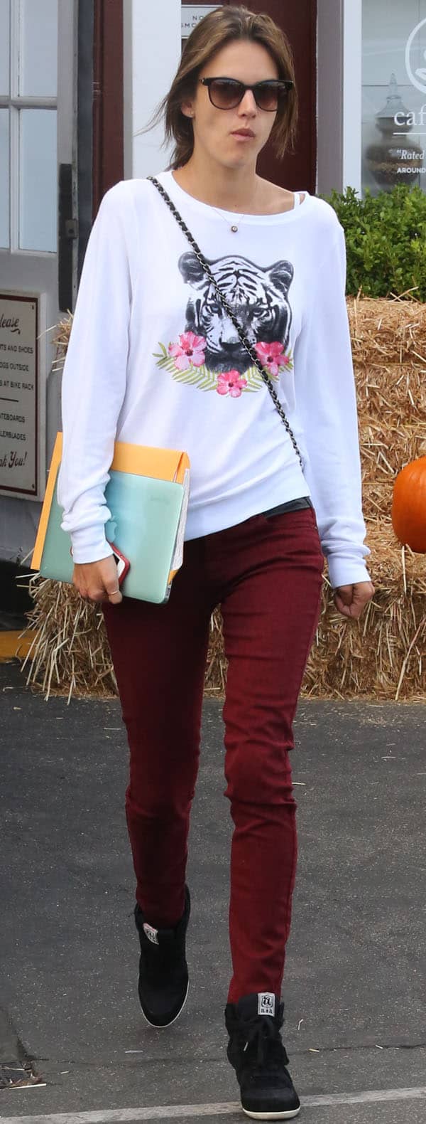Alessandra Ambrosio in red leopard-print jeans by BlankNYC and a tiger-print graphic shirt