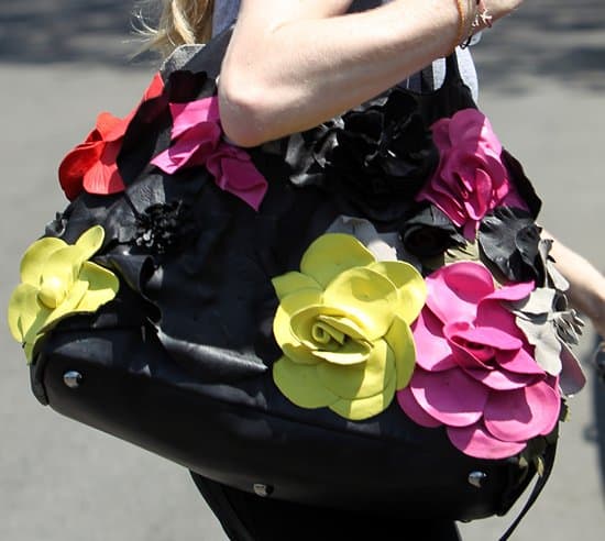 A close-up of Amanda Seyfried's elegant and floral leather bag, showcasing intricate design and craftsmanship