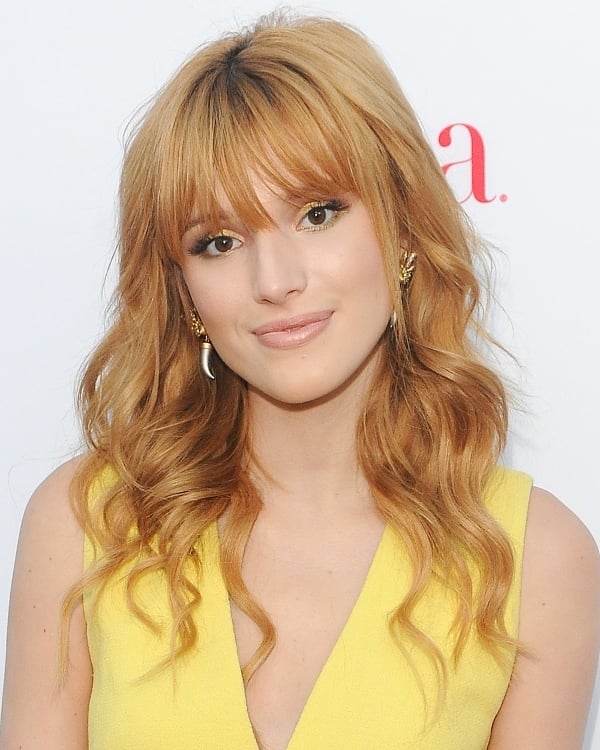 Bella Thorne's gold tusk earrings and gold eyeshadow