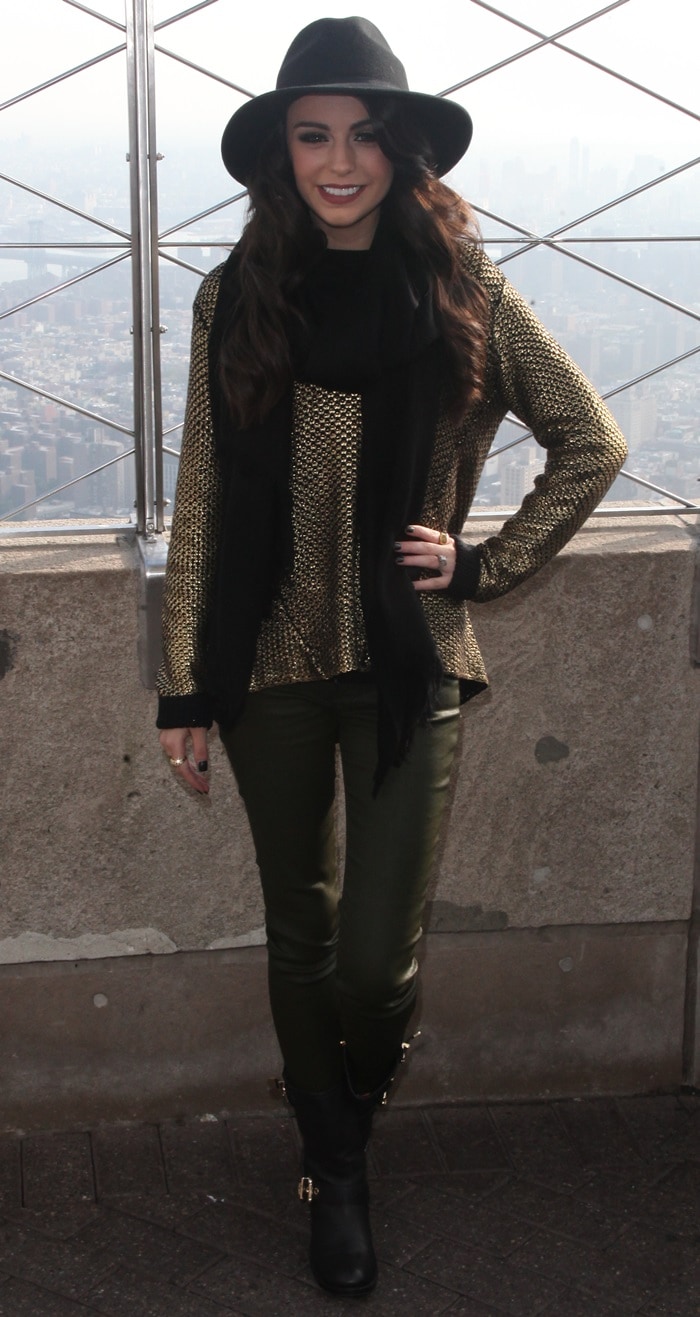 Cher Lloyd paired a metallic bronze sweater with dark green leather pants