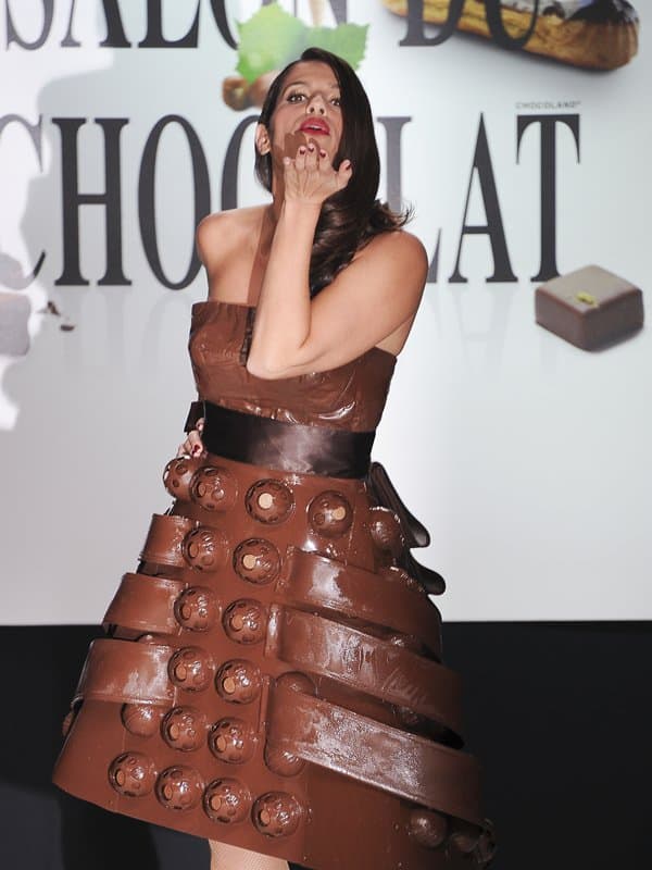 Model blows a kiss while wearing a playful chocolate dress at the 2013 Chocolate Fashion Show