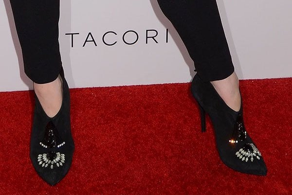 Detail shot of Christina Hendricks' chic Emporio Armani suede ankle booties, adorned with beads, rhinestones, and Swarovski crystals, adding a sparkle of glamour to her outfit at the Tacori event