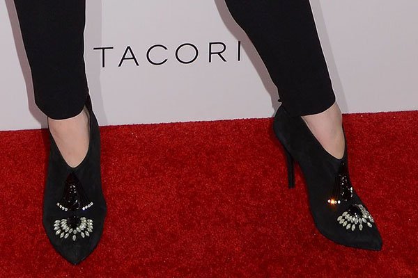 Detail shot of Christina Hendricks' chic Emporio Armani suede ankle booties, adorned with beads, rhinestones, and Swarovski crystals, adding a sparkle of glamour to her outfit at the Tacori event