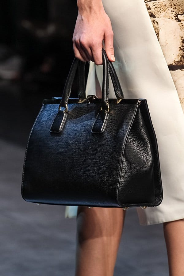 The minimalist design and sleek structure make this black handbag a versatile accessory, perfect for adding sophistication to any outfit