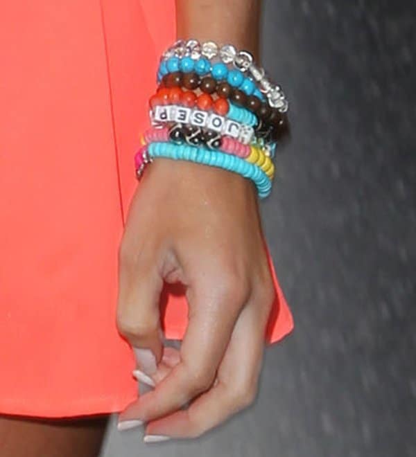 Emily Maynard adds a pop of color to her outfit with a stack of vibrant bracelets, perfect for jazzing up any casual look
