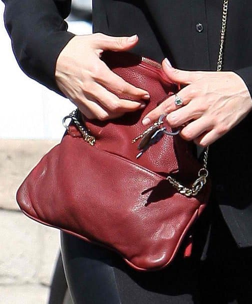 Emmy Rossum adds a pop of color with a red Zadig & Voltaire Rock Tresse pochette, complementing her coral-red lips
