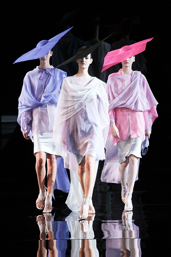 Models showcasing stunning dresses with oversized square hats at Giorgio Armani's Milan Fashion Week show