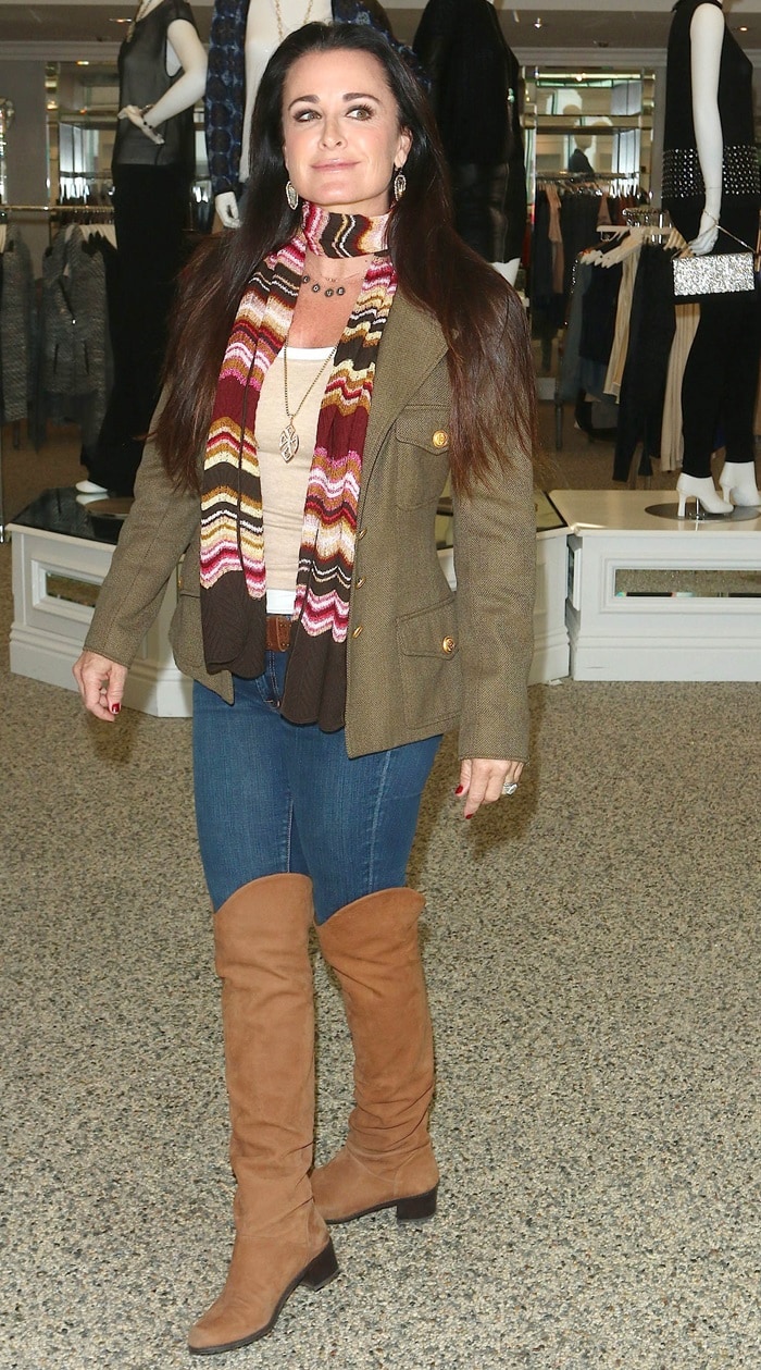 Kyle Richards wears a colorful scarf with jeans and over-the-knee boots