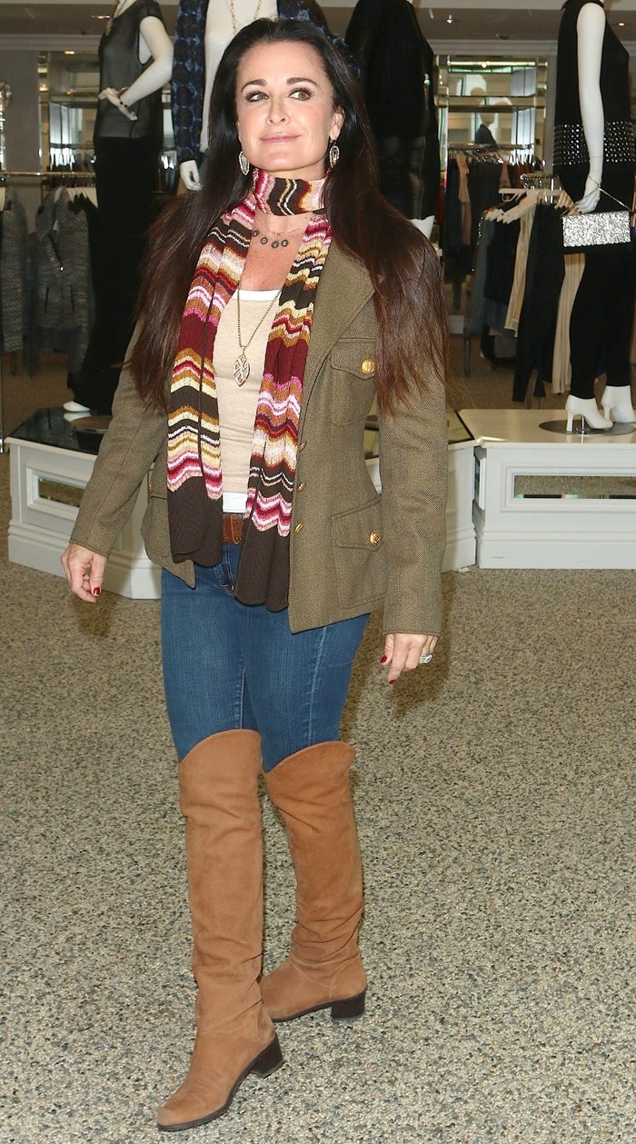 Kyle Richards completes her casual look with a colorful scarf, jeans, and over-the-knee boots