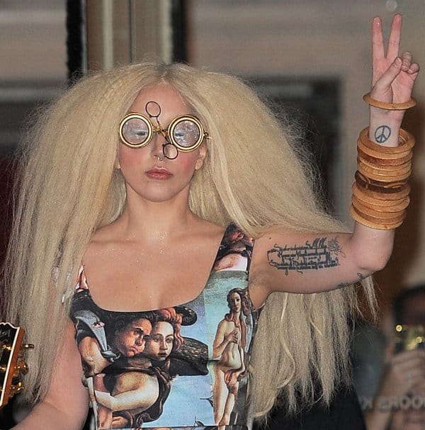 Lady Gaga accessorized with stacks of wooden bangles and dorky steampunk goggles