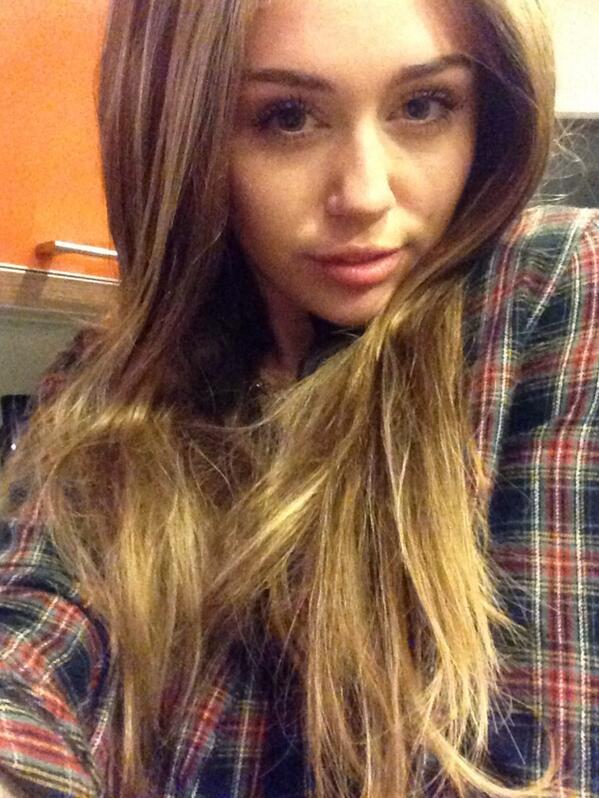 Miley Cyrus wears a long brown wig