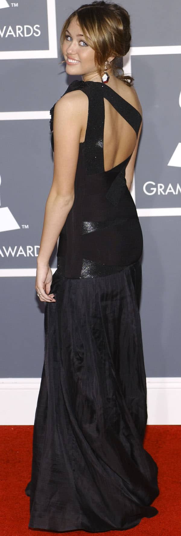 Miley Cyrus looked stunning in a long black cut-out Herve Leger dress