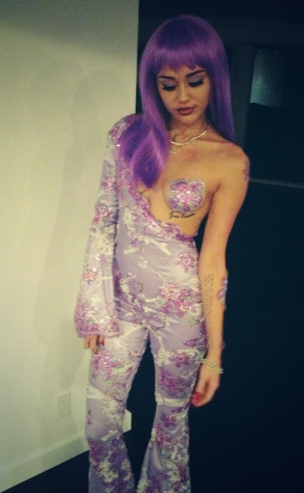 Miley Cyrus' long purple wig and dramatic makeup