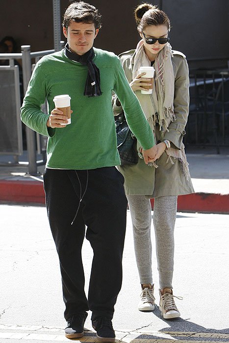 Orlando Bloom grabs Miranda Kerr's hand as the brunette haired beauty crosses the street