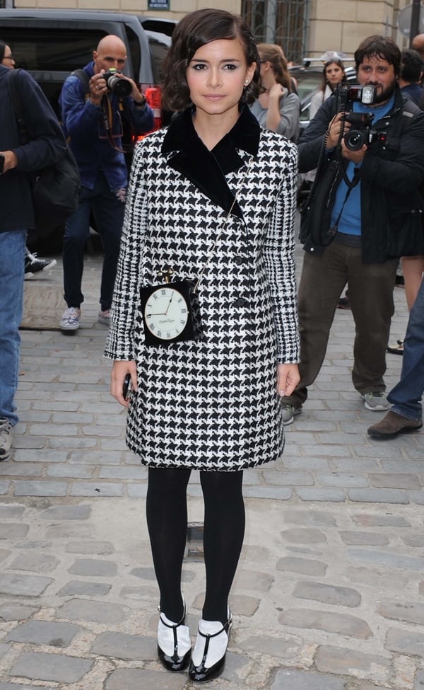 Miroslava Duma at the Giambattista Valli Spring/Summer 2014 show during Paris Fashion Week in France on September 30, 2013, in a stylish houndstooth coat