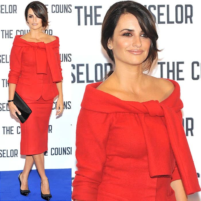 Penélope Cruz in a red tie-shoulder wool jacket and matching below-the-knee skirt at the press junket and photo call for The Counselor