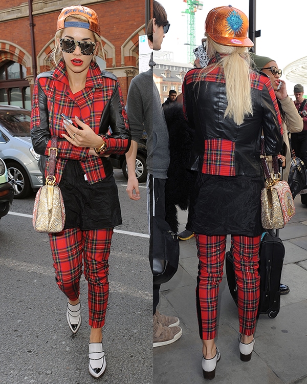 Rita Ora was spotted returning to London via Eurostar on October 2, 2013, wearing a Karl Lagerfeld Vicious leather-trimmed tartan wool biker jacket, Karl Lagerfeld Macpherson tartan wool and faux leather pants, Chanel Fall 2013 calfskin short boots, and carrying a Dolce & Gabbana Fall 2013 purse