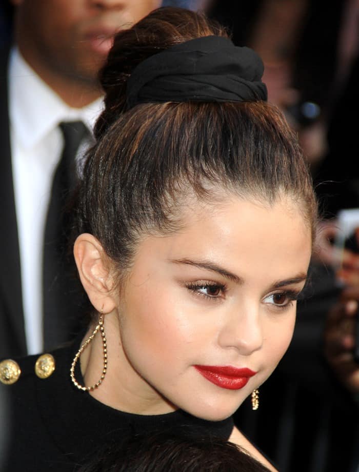 Selena Gomez's tousled high-top braid perfectly complemented her choice of large pyramid drop earrings
