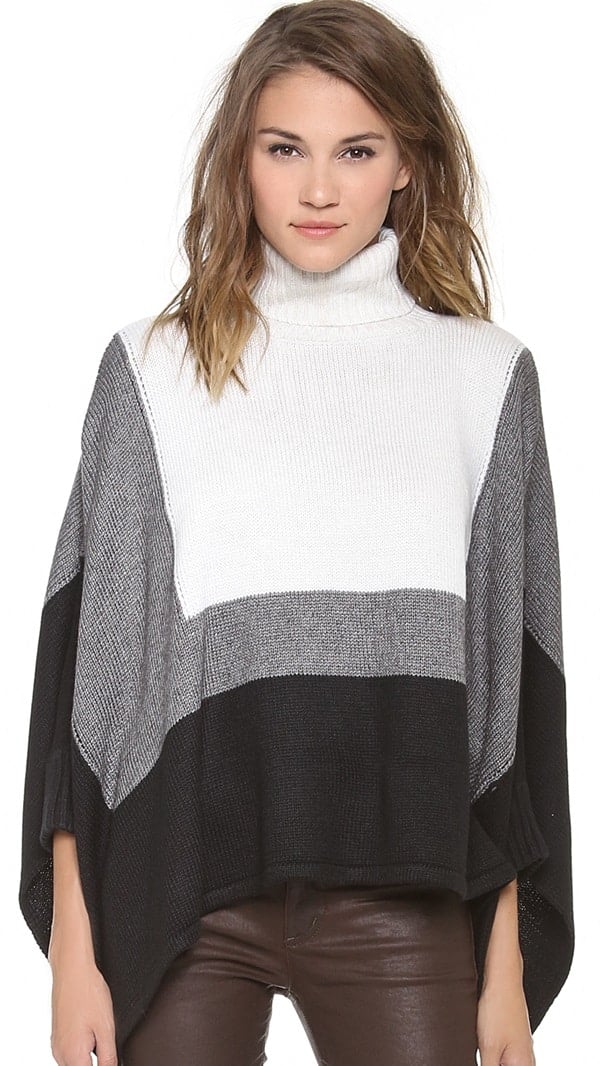 An oversized cut and fitted dolman sleeves bring unique proportions to this colorblock turtleneck sweater
