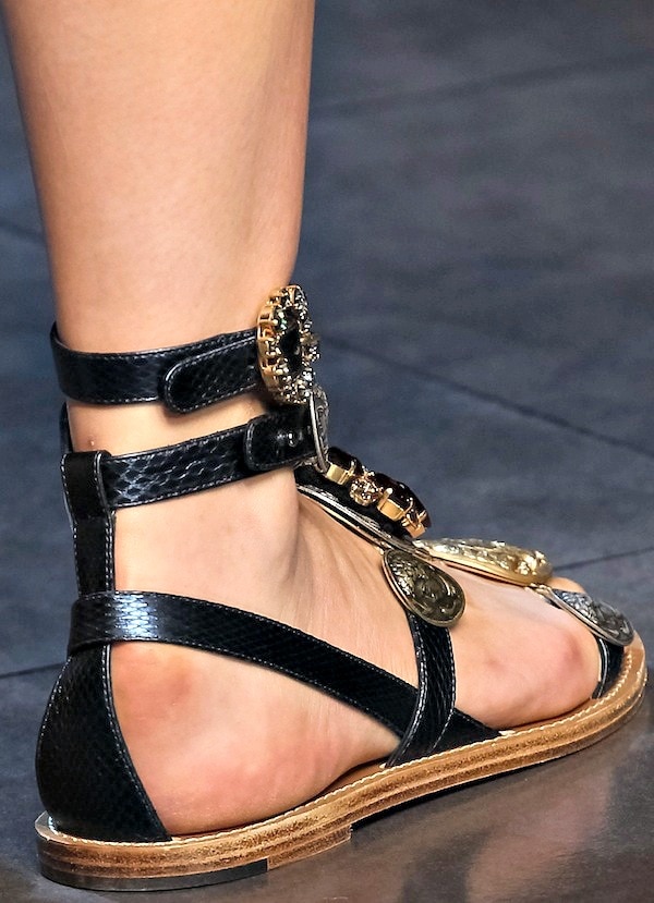 Black Dolce & Gabbana flat sandals with gold coin embellishments and multiple straps