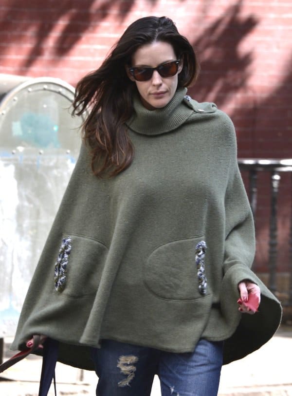 Liv Tyler looks stylish and cozy with her sunnies and poncho during a morning dog walk in Manhattan