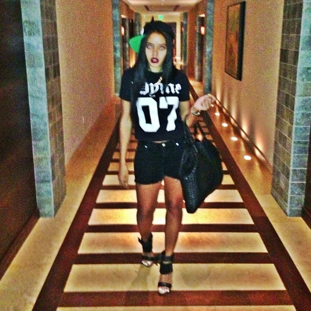 Angela Simmons styles a pair of black MIA Limited Edition "Rocco" sandals with a graphic t-shirt and shorts