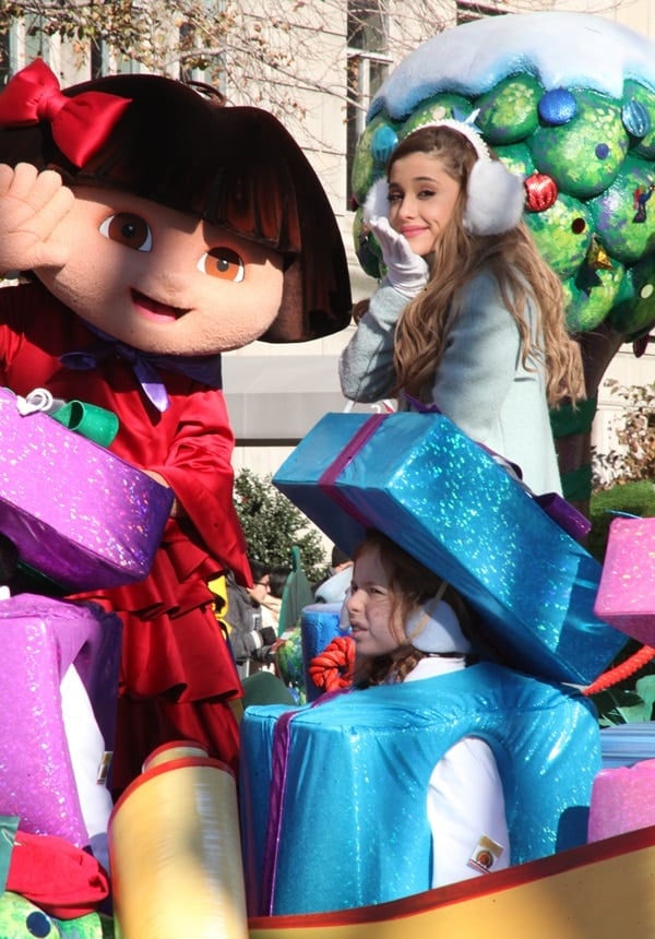 Ariana Grande blows a kiss as she performs on a Dora the Explorer-themed float