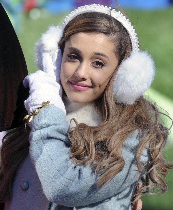 Ariana Grande warms up with white gloves and white fuzzy earmuffs