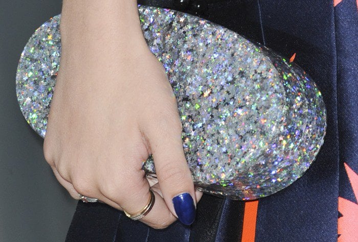 Bella Thorne totes a glittering silver Edie Parker clutch