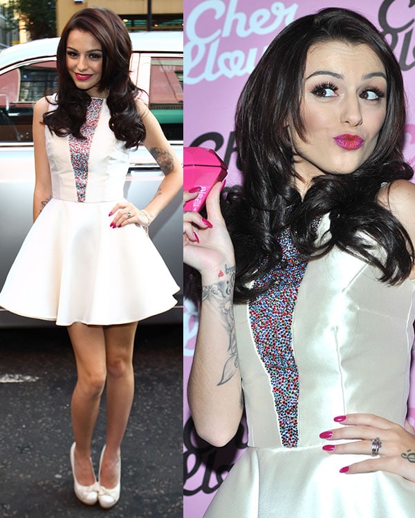 Cher Lloyd looks playful and chic in a flirty white dress with colorful beaded detailing at her fragrance launch, paired with classic white heels and a bold pink lip in London