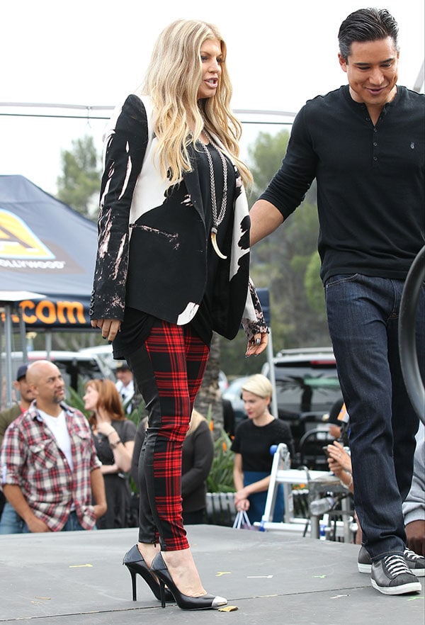 Fergie rocking a trendy black-and-red plaid look with metal-toed pumps during an appearance on 'Extra'