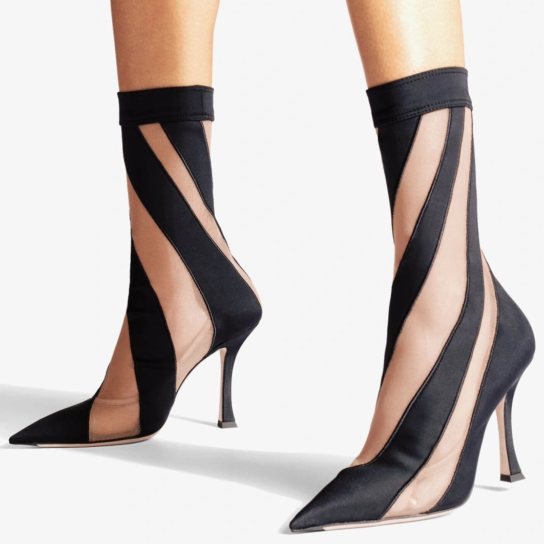 Vibrant sock boots from Jimmy Choo x Mugler featuring pointed toes and black fabric uppers with semi-sheer mesh inserts