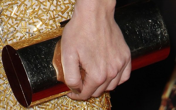 Jena Malone styled her look with a gold Jimmy Choo clutch and gold manicure